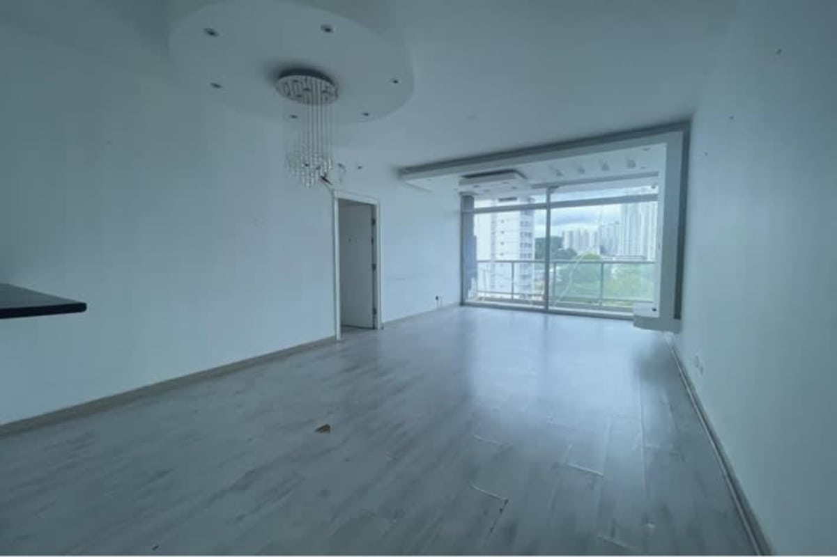 Spacious living room with large windows balcony skyline view PH El Cangrejo Suites Panama