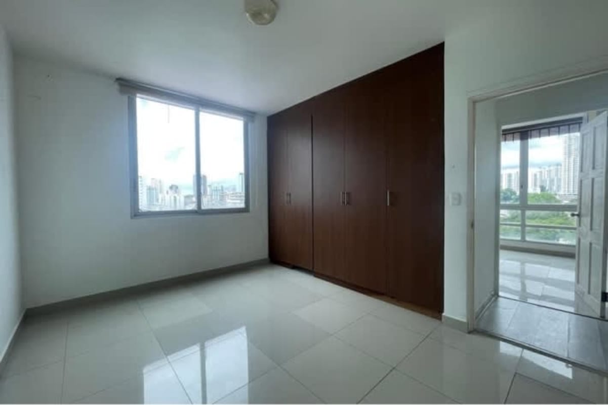 Empty bedroom built-in wooden closet large window city view PH El Cangrejo Panama