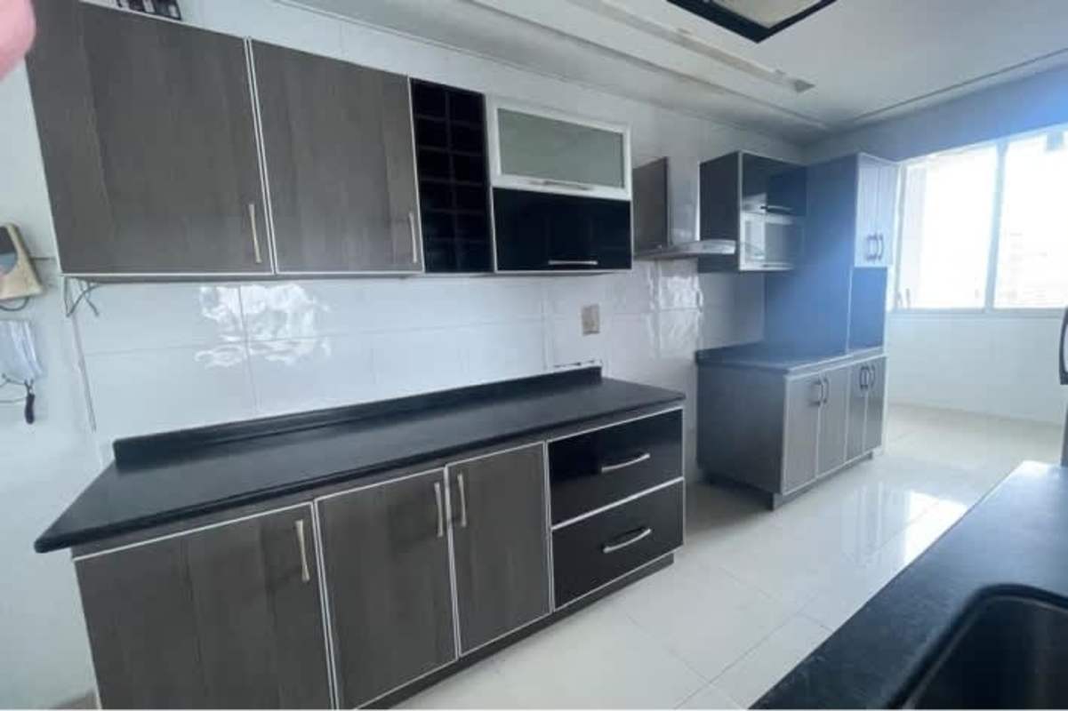 Apartment kitchen large window ample cabinetry black countertops El Cangrejo