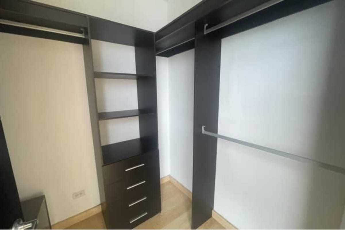 Spacious custom walk-in closet with wood shelving penthouse El Cangrejo Tower