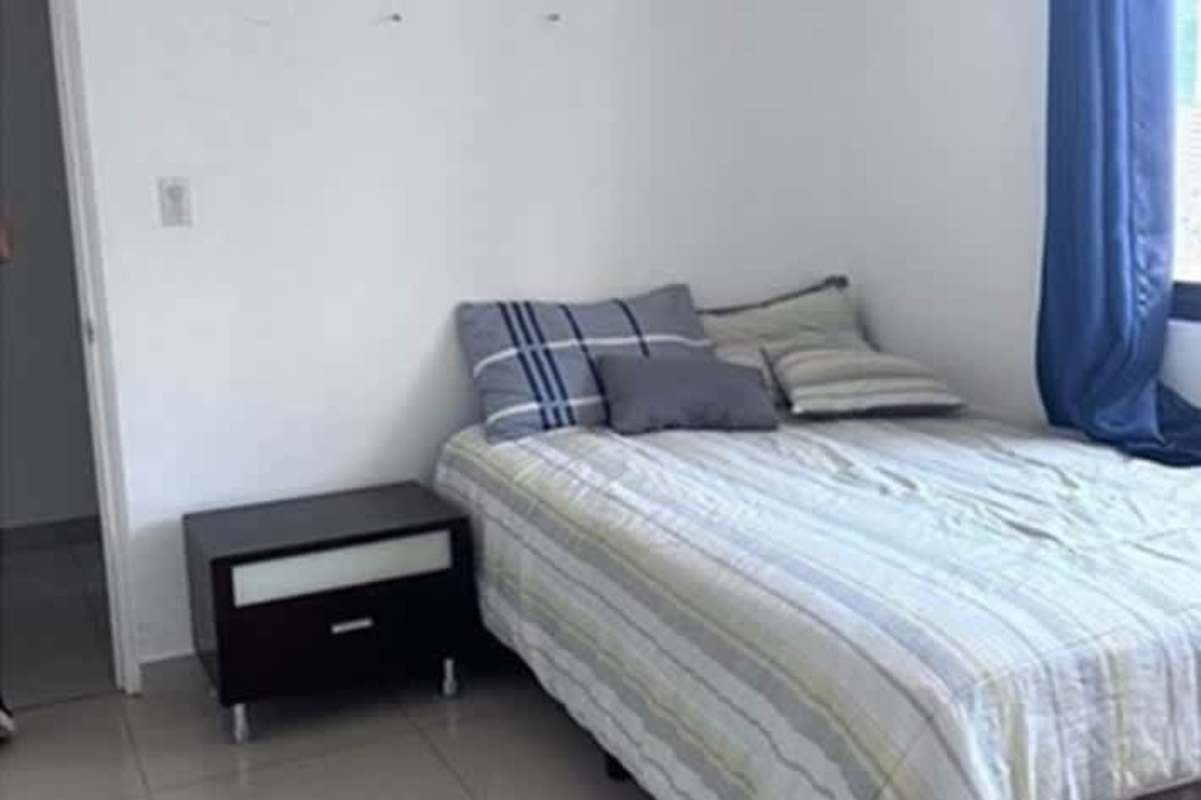Simple bedroom with large window, minimalist decor at PH Punta Paitilla Panama City