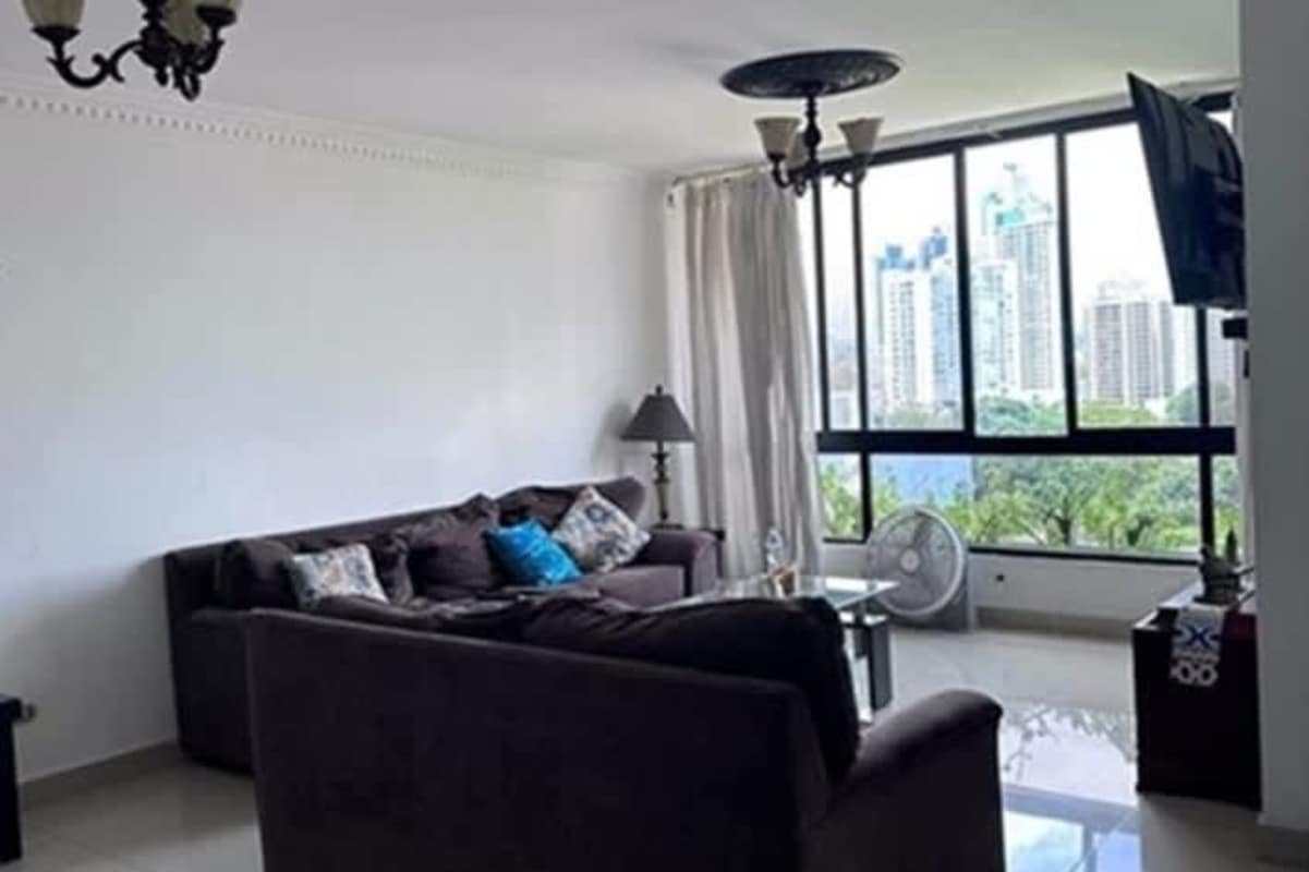 Living room with large windows and city view at PH Punta Paitilla Panama City