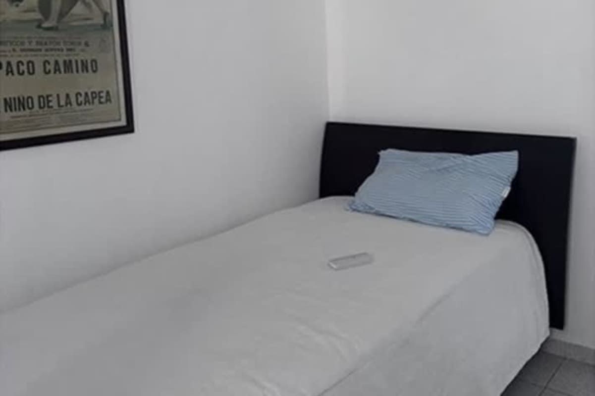 Living room with sectional sofa, floor lamp, large windows, and city views at PH Punta Paitilla Panama City