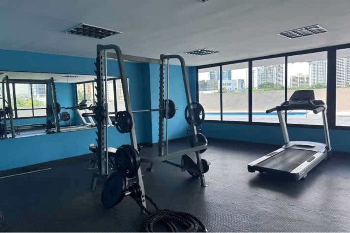 Indoor gym with large windows, modern workout equipment in PH Punta Paitilla Panama City