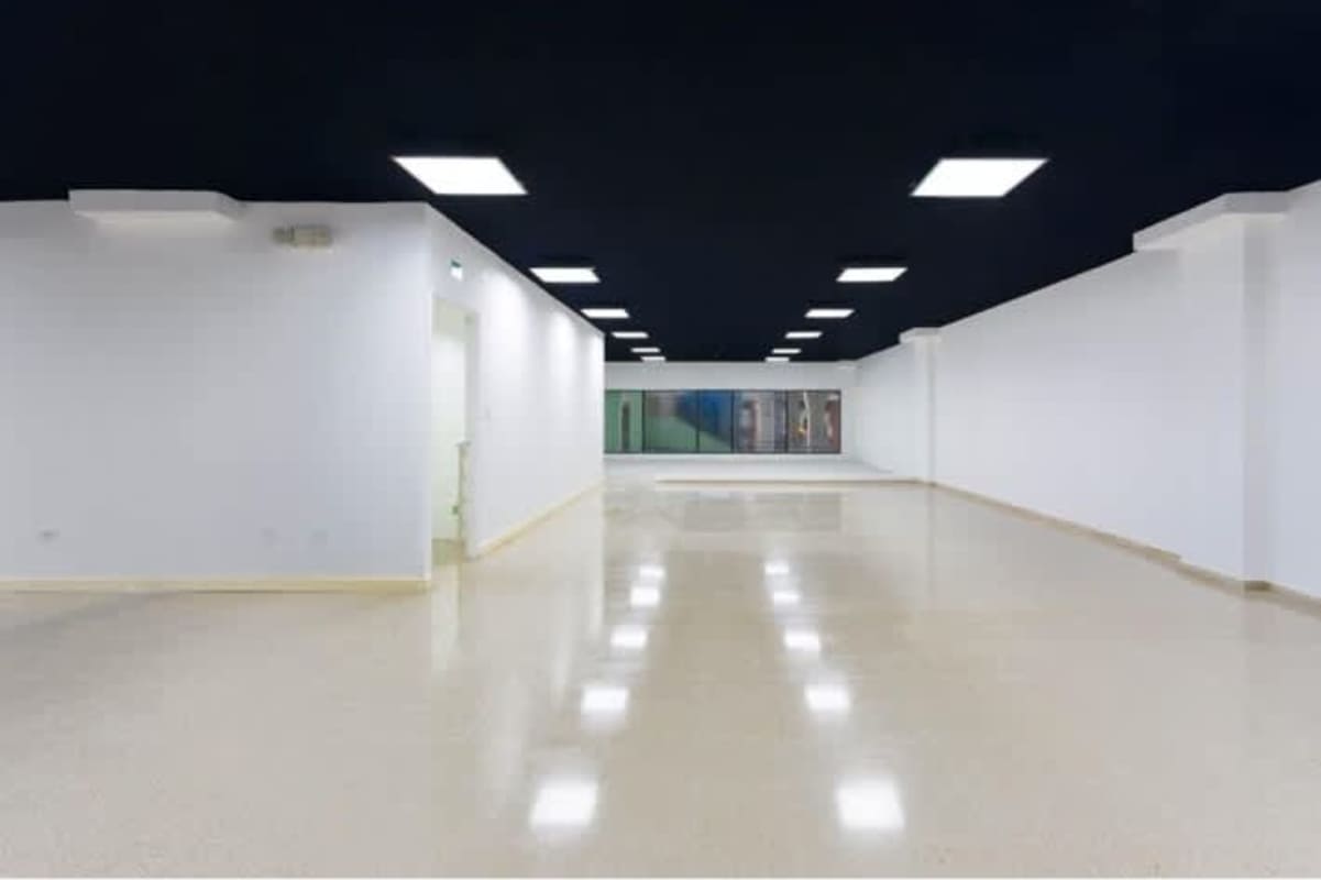 Exterior front of commercial unit with double height glass facade and signage space