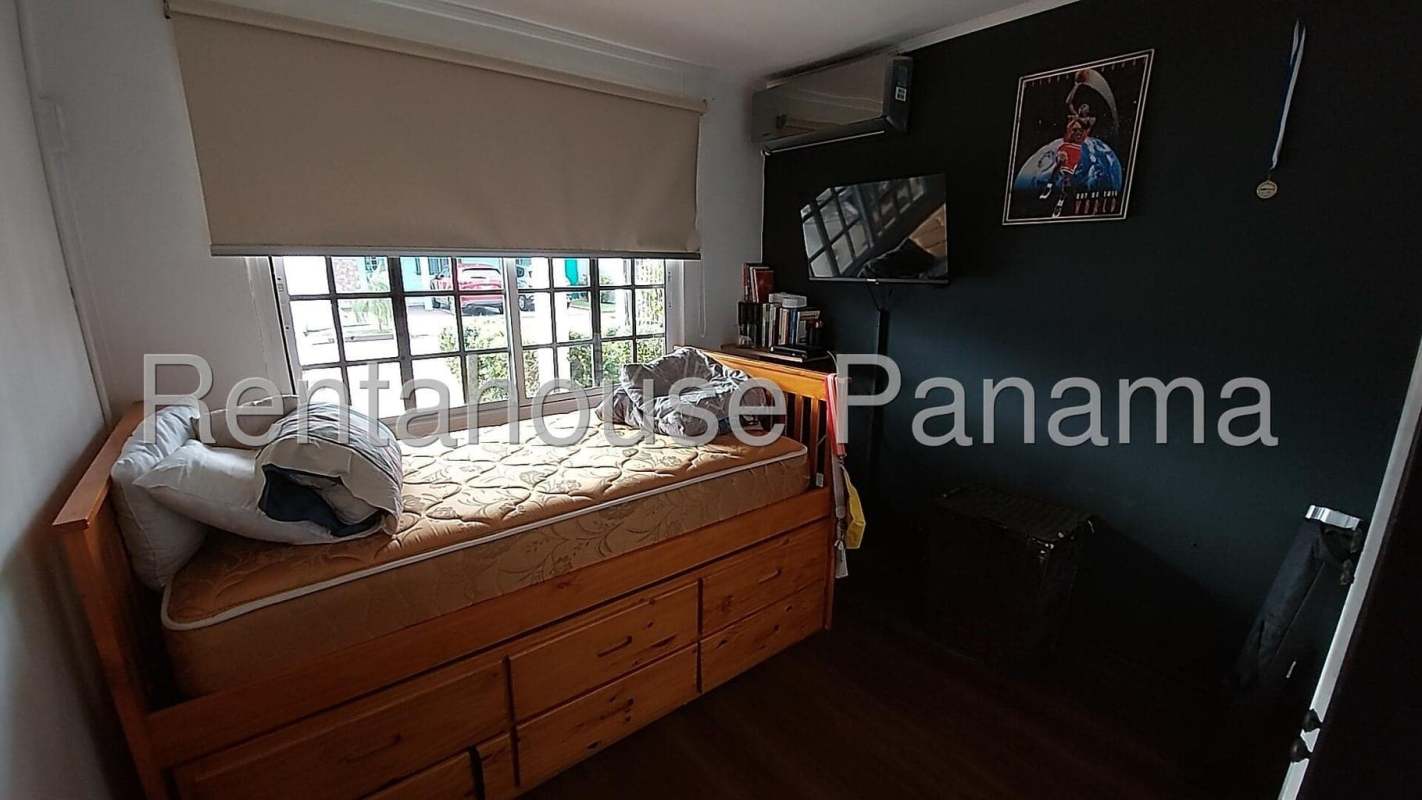 Kitchen with wooden cabinets, granite countertops, and appliances in La Fontana Chanis Panama