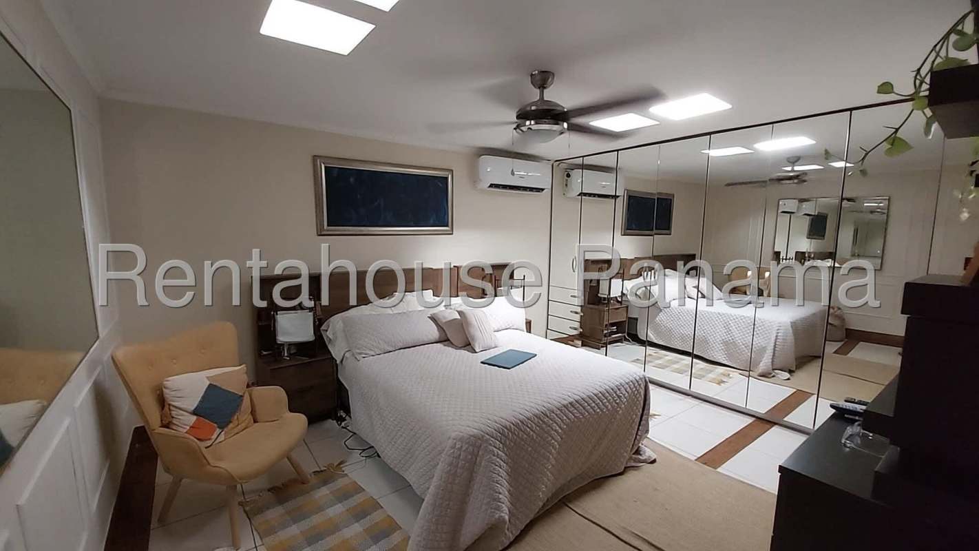 Bathroom with vessel sink, glass shower, and wood accents in Panama City house for sale