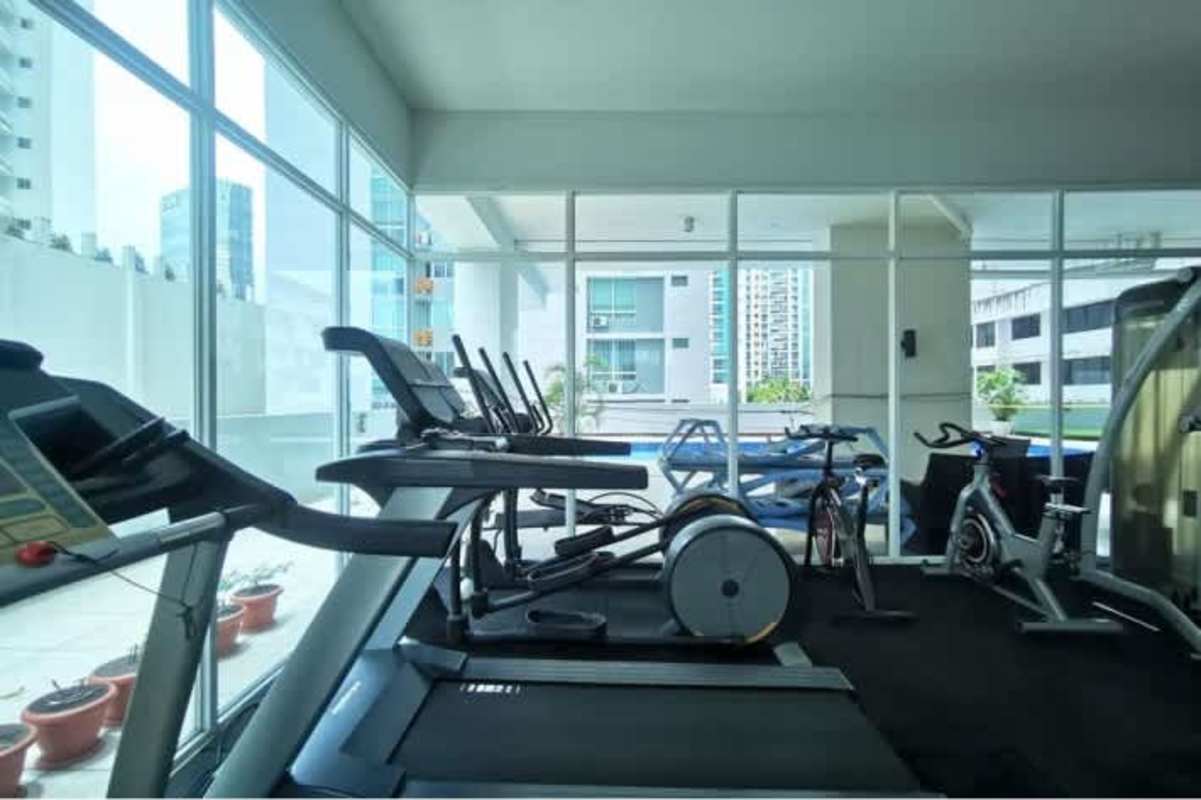 Modern fitness center with cardio and weight equipment at PH Blue Park Bella Vista Panama City