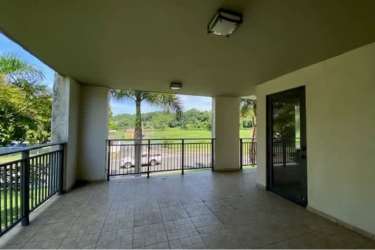 Modern open-concept living and dining area with large windows and balcony access