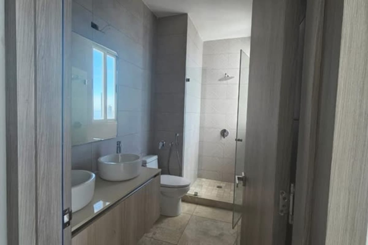 Luxury bathroom double sinks walk-in glass shower marble walls Bella Vista Panama