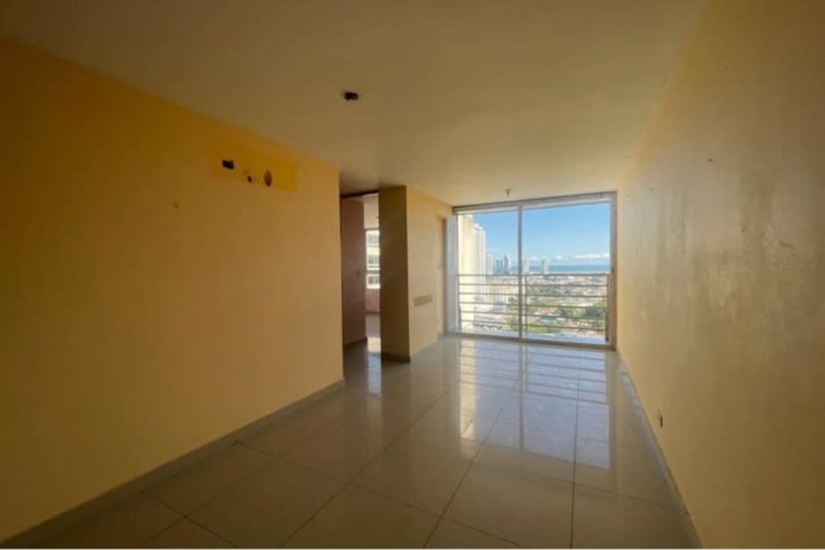 Bright living area with balcony access exhibiting city skyline, Rio Abajo Panama City