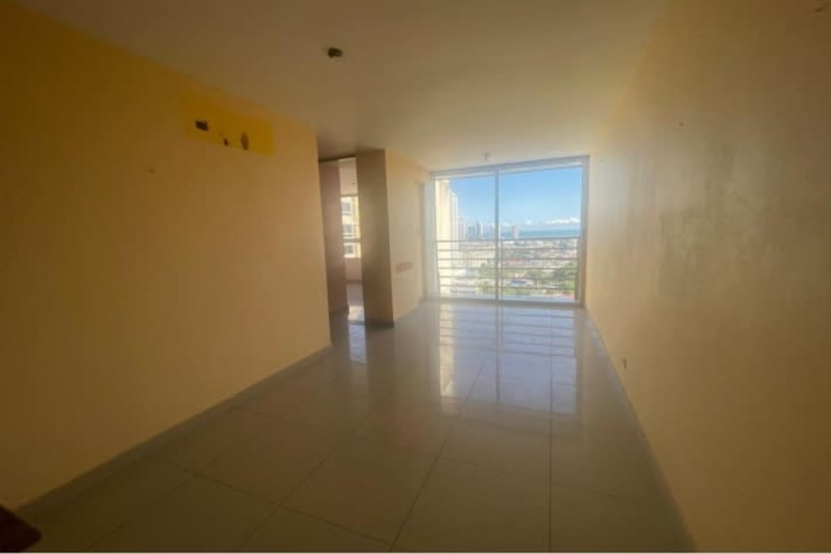 Living room with sliding glass balcony door and city view PH Avenida Cincuentenario Panama
