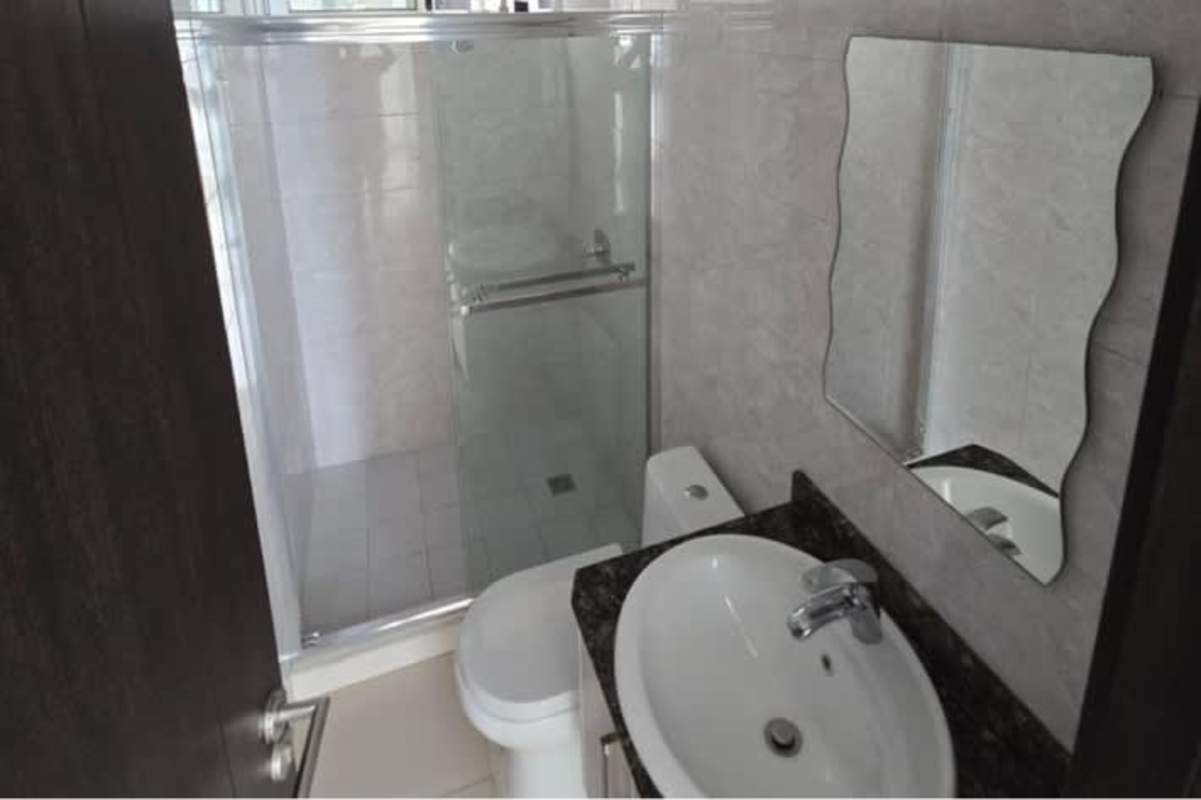 Modern bathroom features glass shower enclosure, granite counter at PH Park Point