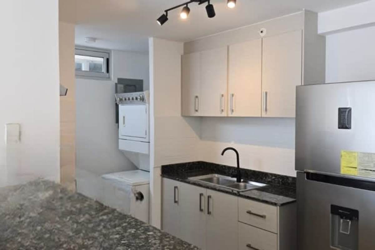 Kitchen with granite countertop, appliances, stackable washer dryer PH Park Point Panama