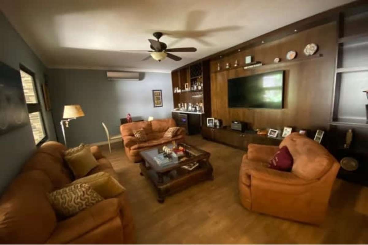 Bright sitting area outside bedrooms with accent chairs in Palmeras del Este house Costa del Este