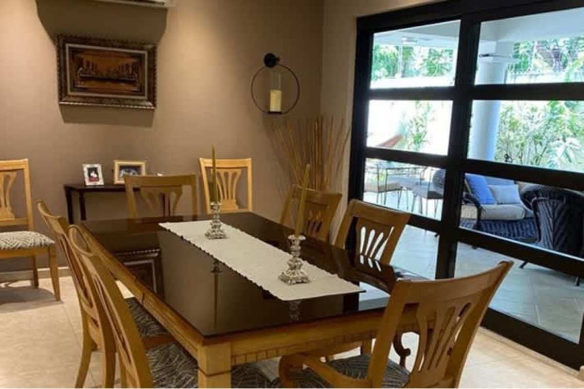 Dining area with glass doors opening to garden in house Costa del Este Panama