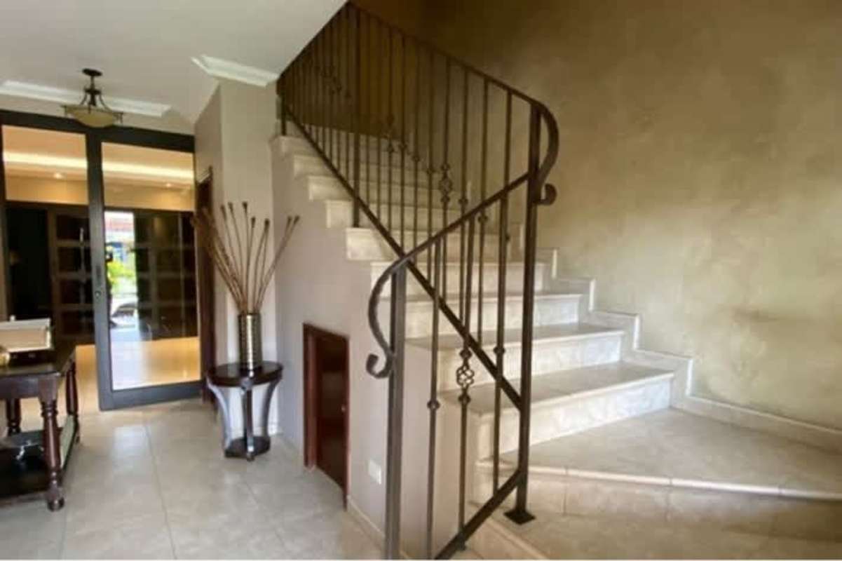 Kitchen with wood cabinets and bright dining space in house Costa del Este