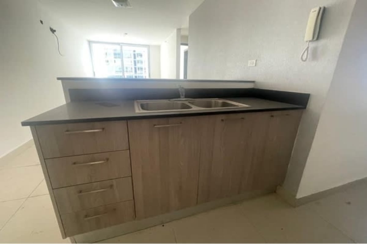 Bright bedroom with large window offering city skyline view PH Park View Carrasquilla Panama City