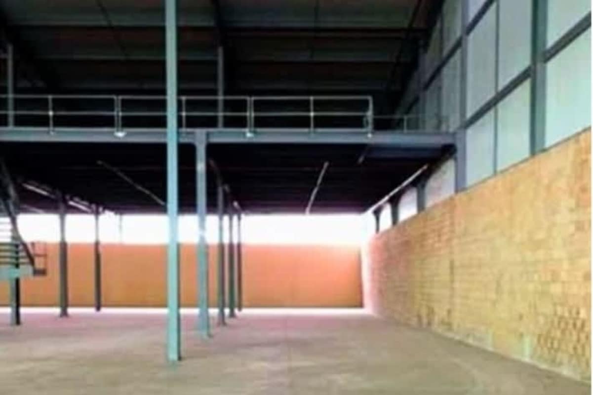 Large open warehouse interior with high ceilings and mezzanine level in San Miguelito Panama