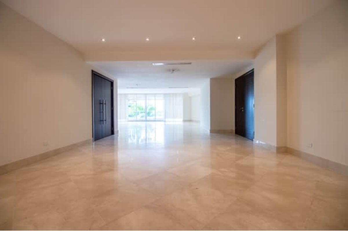 Empty modern condo living room with marble flooring and balcony access PH Miradores Panama