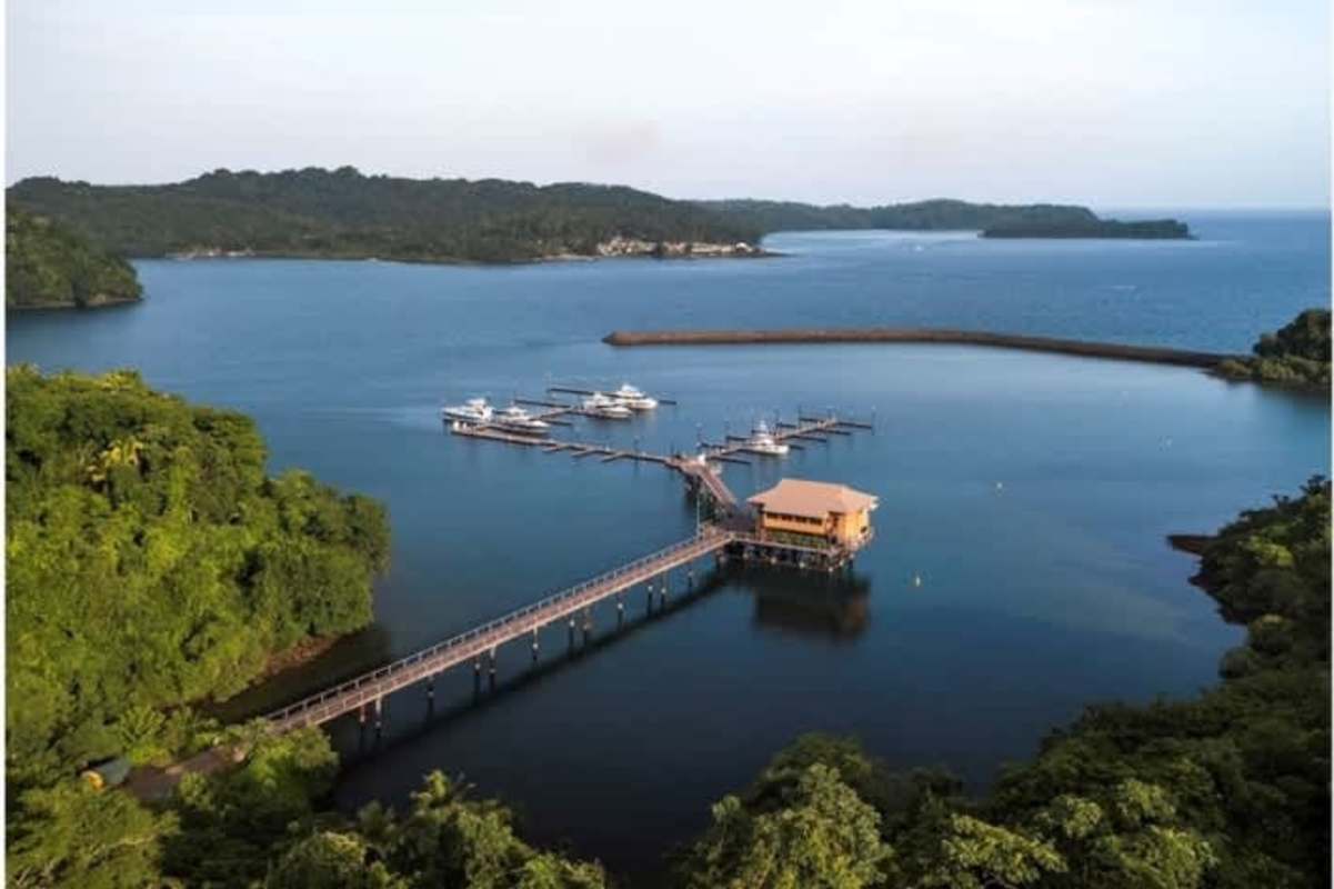 Private marina docks with boats next to lush island plants at Club Residence Las Perlas Archipelago Panama