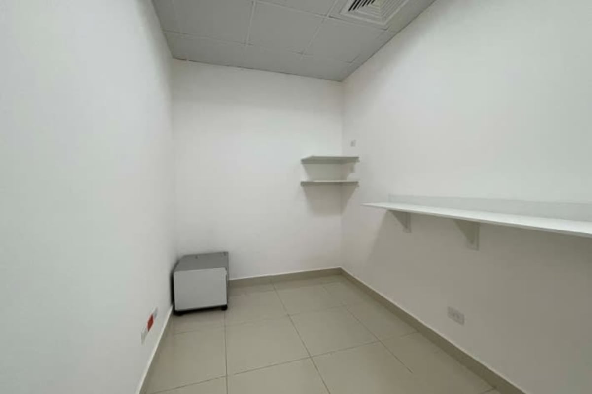 Contemporary office area with green lounge sofa and glass partition Costa del Este Panama