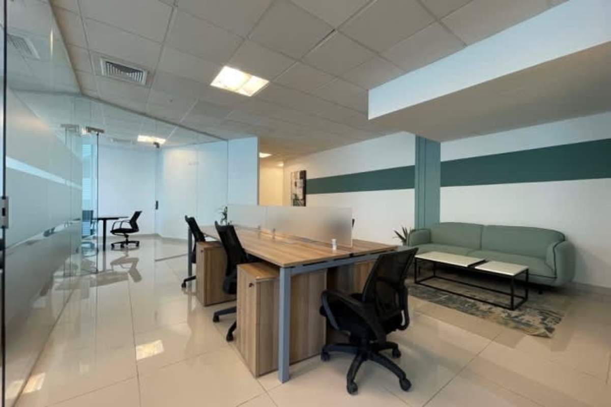 Open office with shared desks, lounge sofa and minimalist setup in Panama