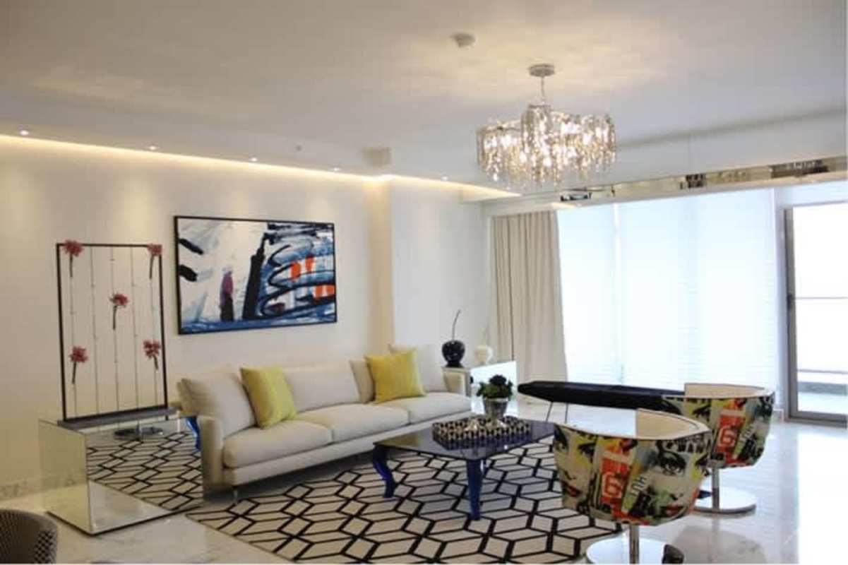 Open plan living and dining area with marble floors and sea-view balcony in PH Regalia