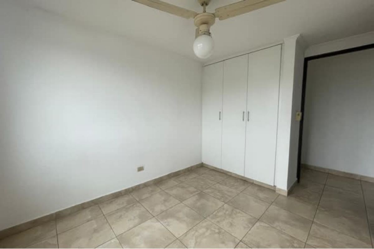 Minimalist bedroom with built-in wardrobe ceiling fan PH Parque Lefevre Panama