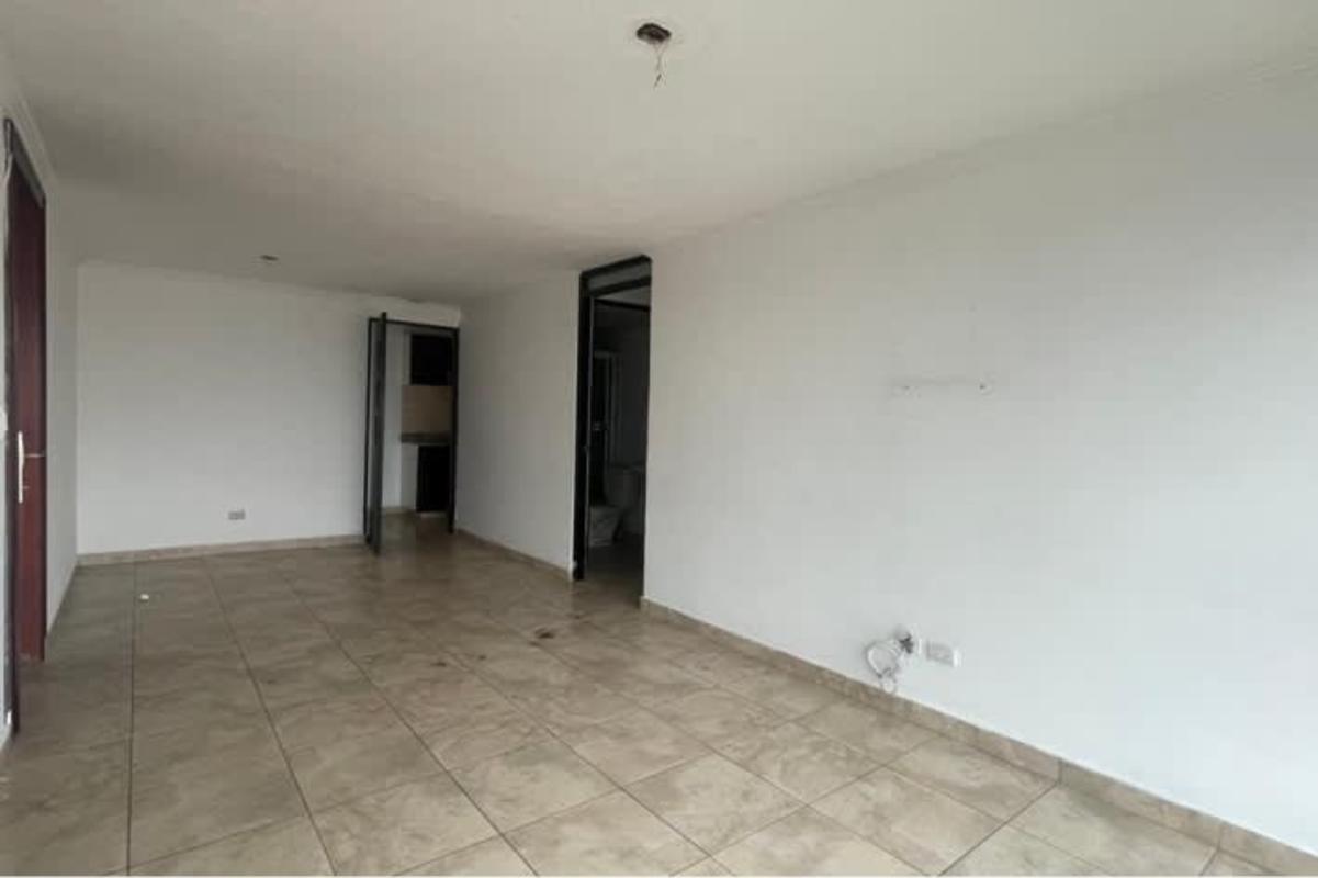 Minimalist living space with white walls and tiled floor PH Parque Lefevre Panama