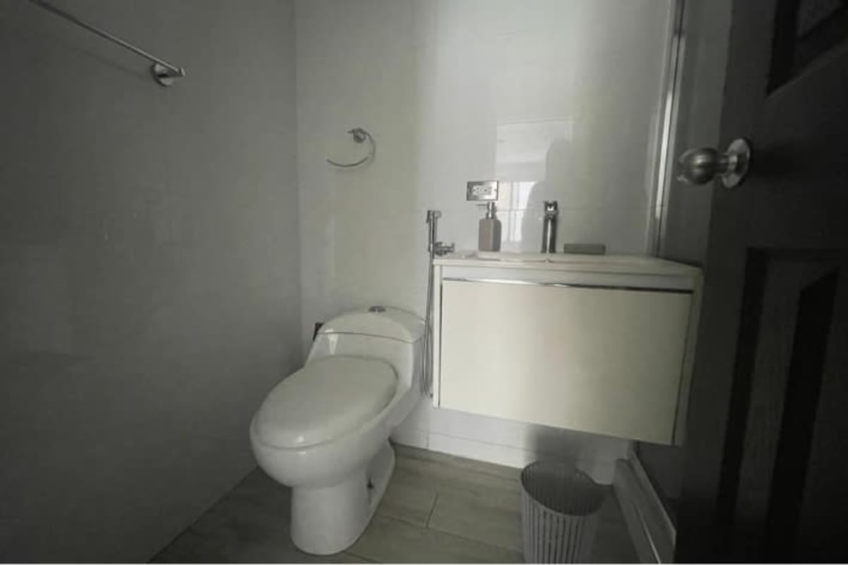 Minimalist bathroom with floating vanity sink and shower at PH Parque Lefevre Panama