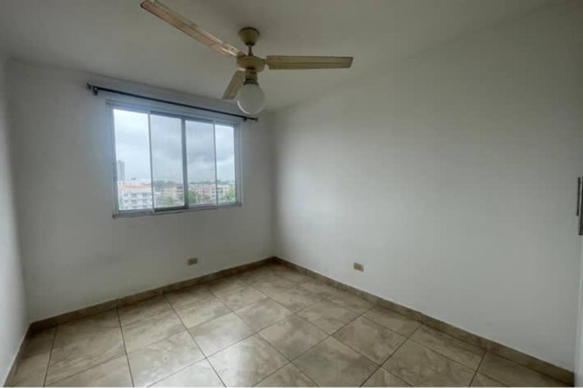 Kitchen with granite countertop, stove, dark cabinets, large window PH Parque Lefevre Panama