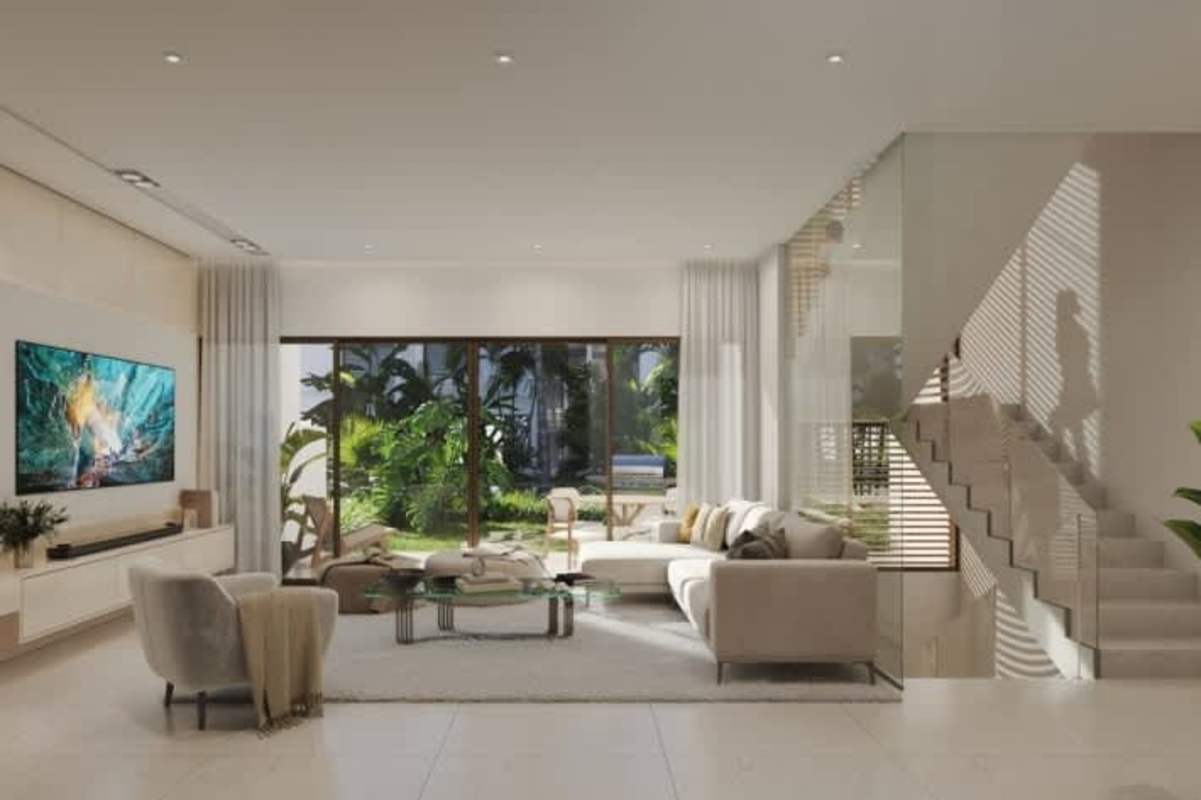 Living room with large sectional sofa, glass wall to garden in Ocean Reef villa Panama City