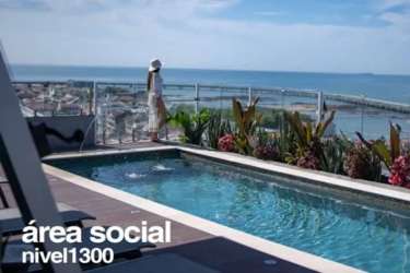 Open-air social terrace with pool views, ocean backdrop, seating area in Casco Viejo Panama