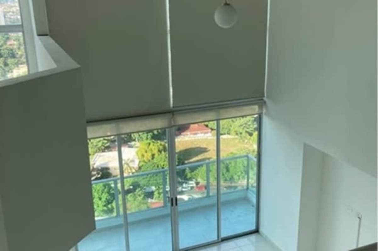 Apartment kitchen with granite countertops, stainless sink, stove and fridge at Park Loft Panama