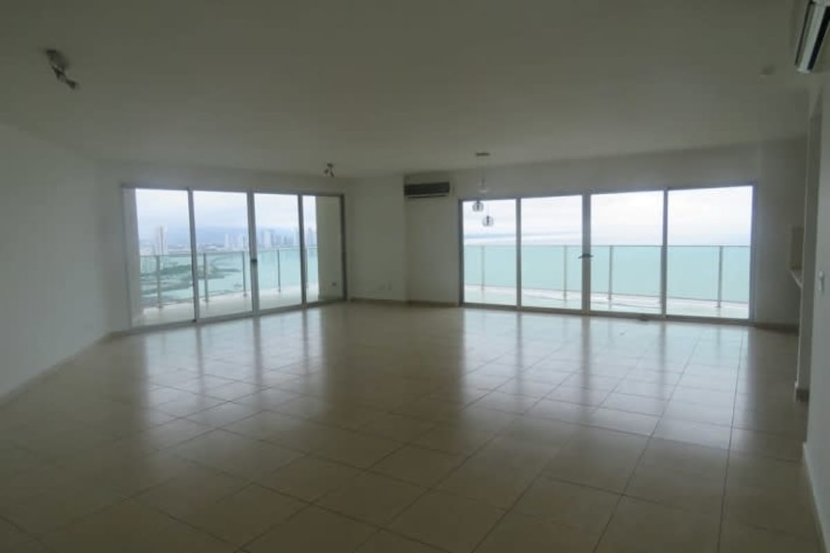 Bright living room with floor-to-ceiling windows and ocean views in luxury Punta Pacifica apartment