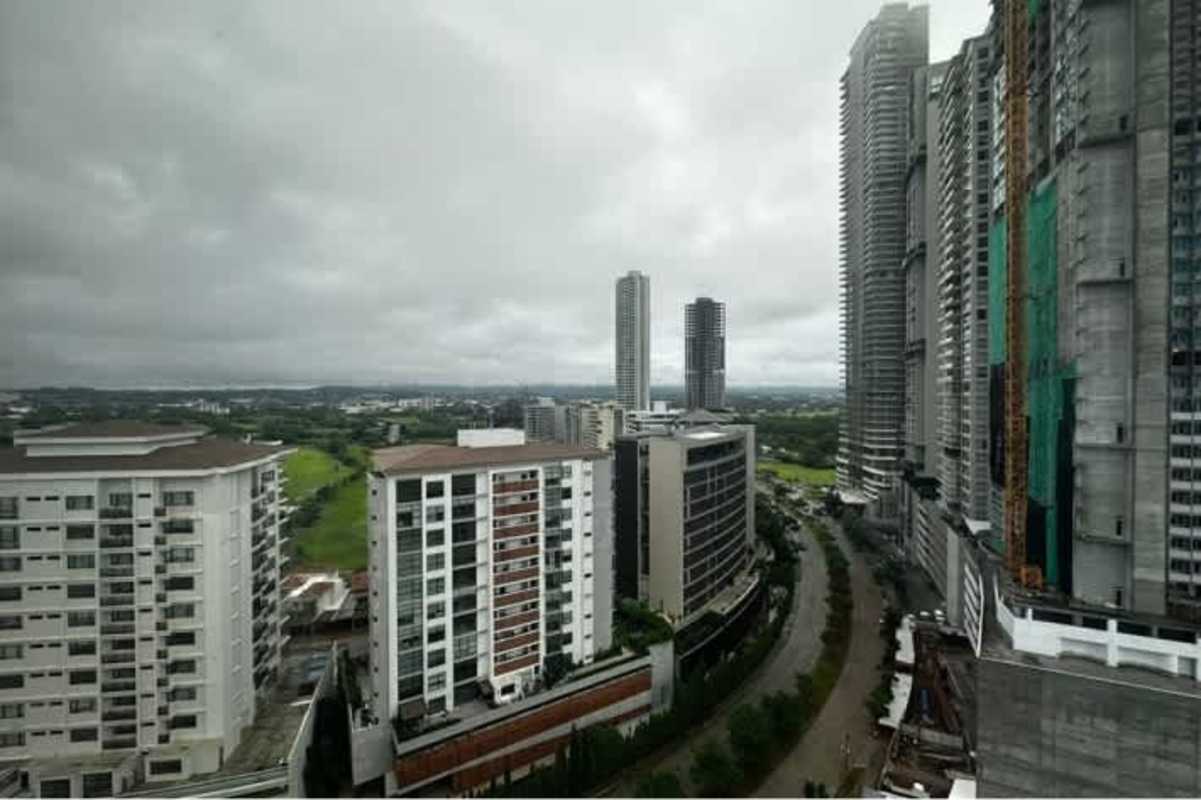 Bedroom with window showing high-rise cityscape from PH Ocean House Santa Maria Panama