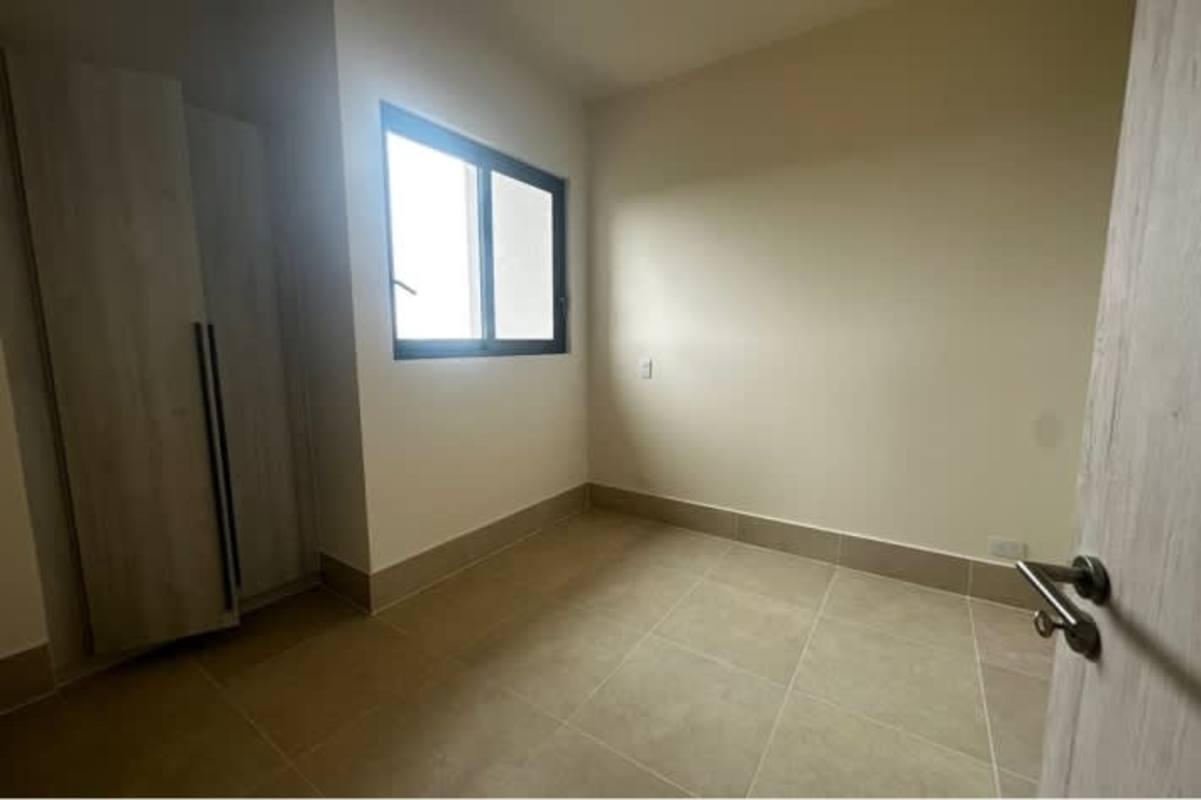 Unfurnished minimalist bedroom with tiled floor and window in Ocean House Santa Maria Panama