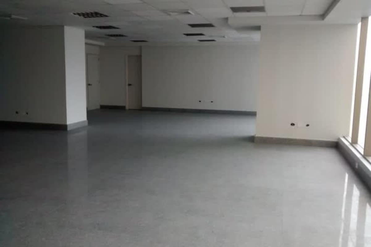 Vacant open-plan office space in BICSA Financial Center with panoramic sea and city views