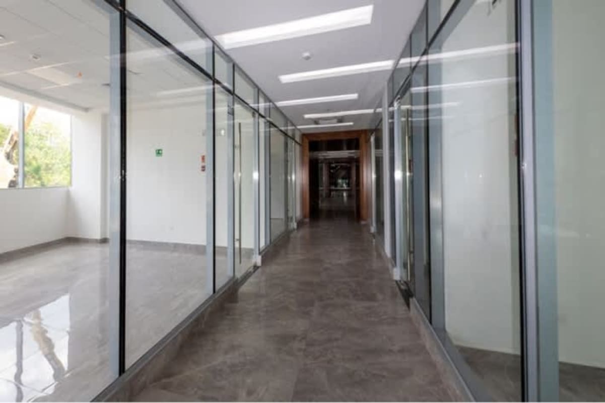 Modern commercial hallway with glass offices and polished floors Plaza Sunset Strip Panama