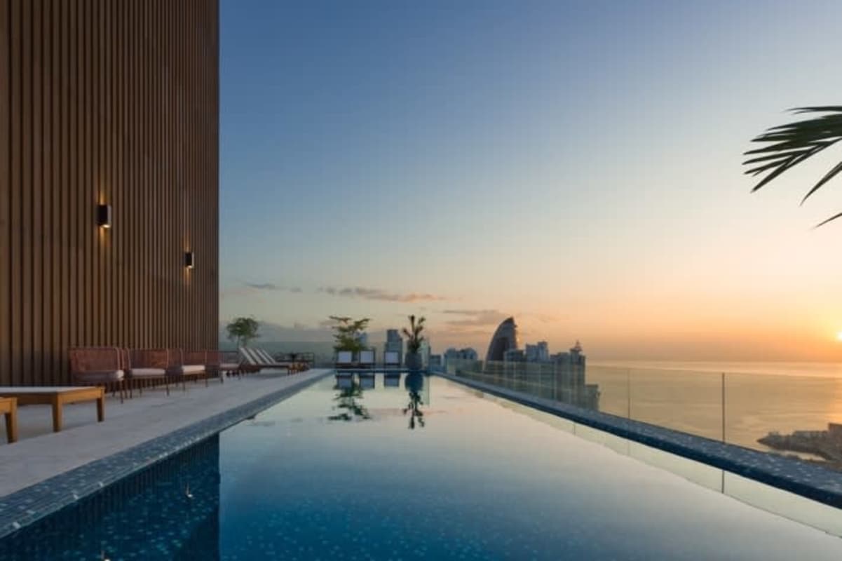 Infinity pool on rooftop overlooking skyline and Pacific Ocean at PH The Towers Panama City