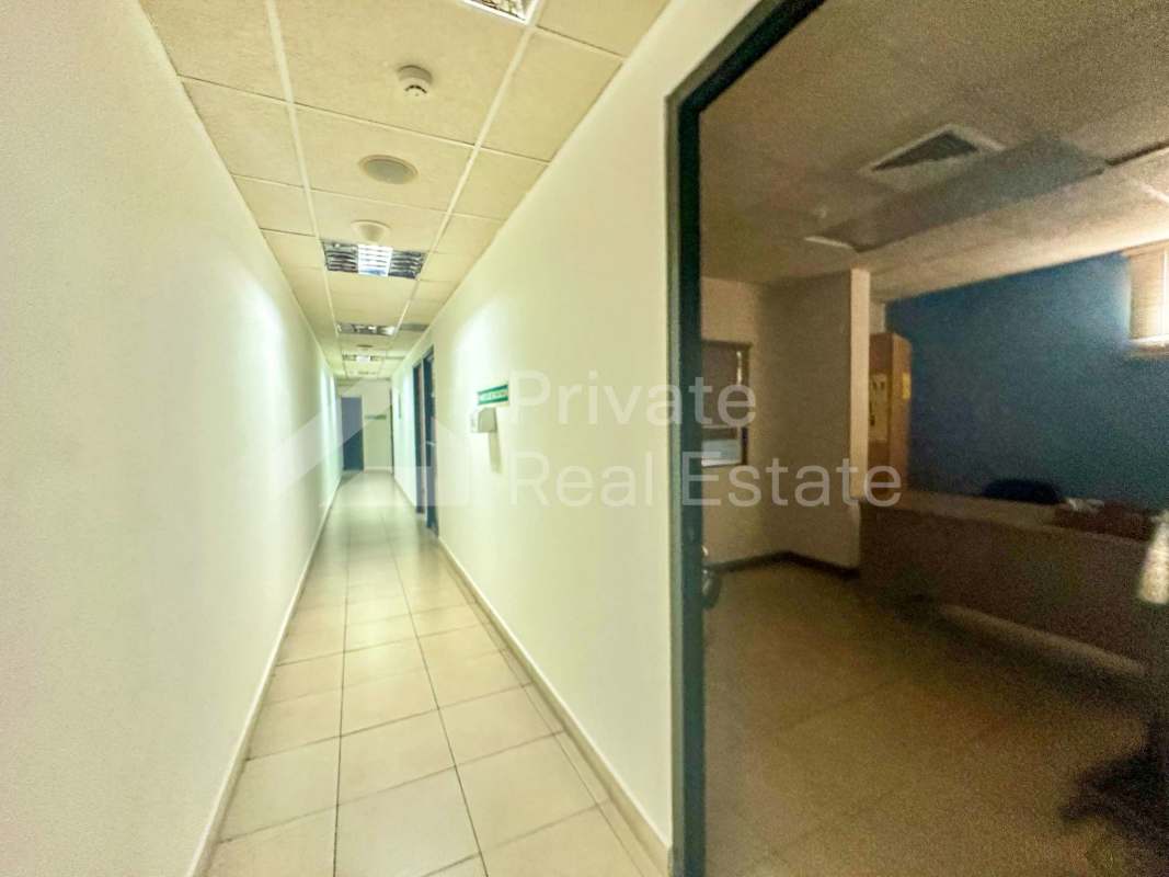 Office area interior hallway with tiled floor and drop ceiling commercial Panama