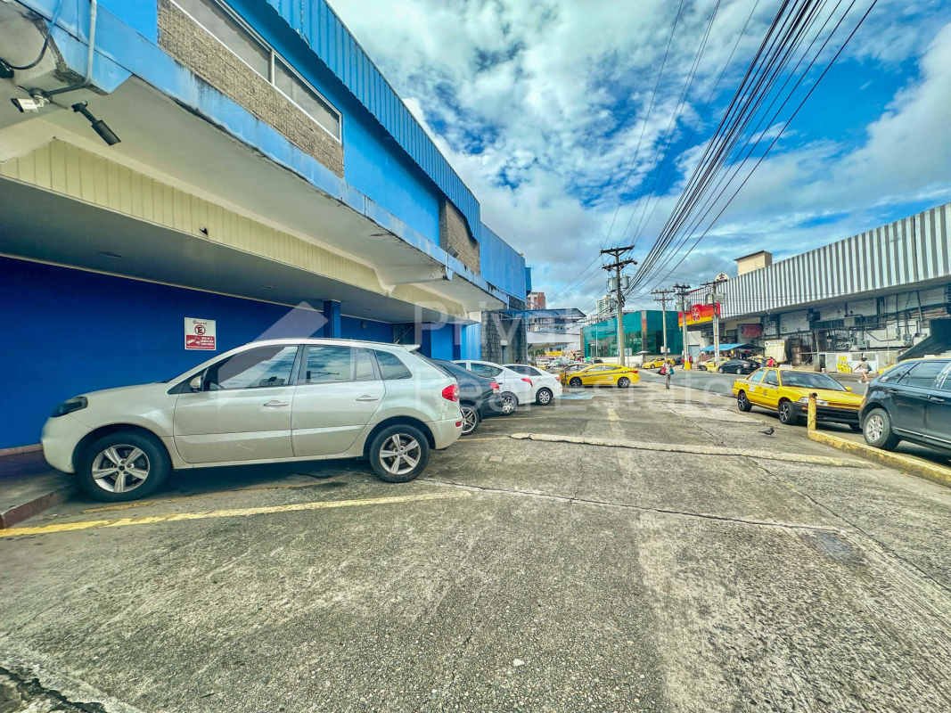 Exterior view of two-story commercial building with blue facade and parking lot in Panama City