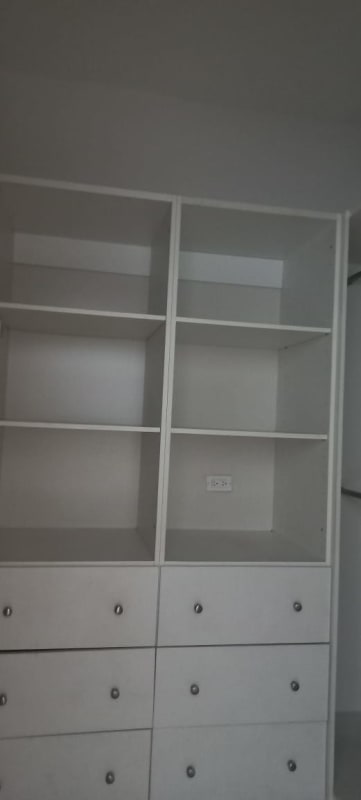 Modern white walk-in closet with drawers and shelves PH GrandBay Tower Panama