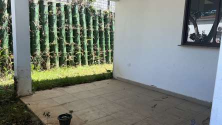 Covered patio and backyard garden with privacy fence in Eco Garden Residences Panama