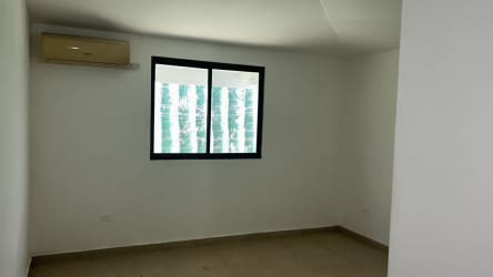 Bedroom with split air conditioning and large window in Eco Garden Residences Arraiján Panama