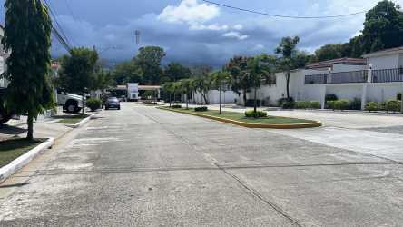 Single story house exterior with porch garden and parking in Eco Garden Residences Panama