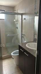 Contemporary bathroom with glass shower enclosure and granite vanity in Eco Garden Residences Panama