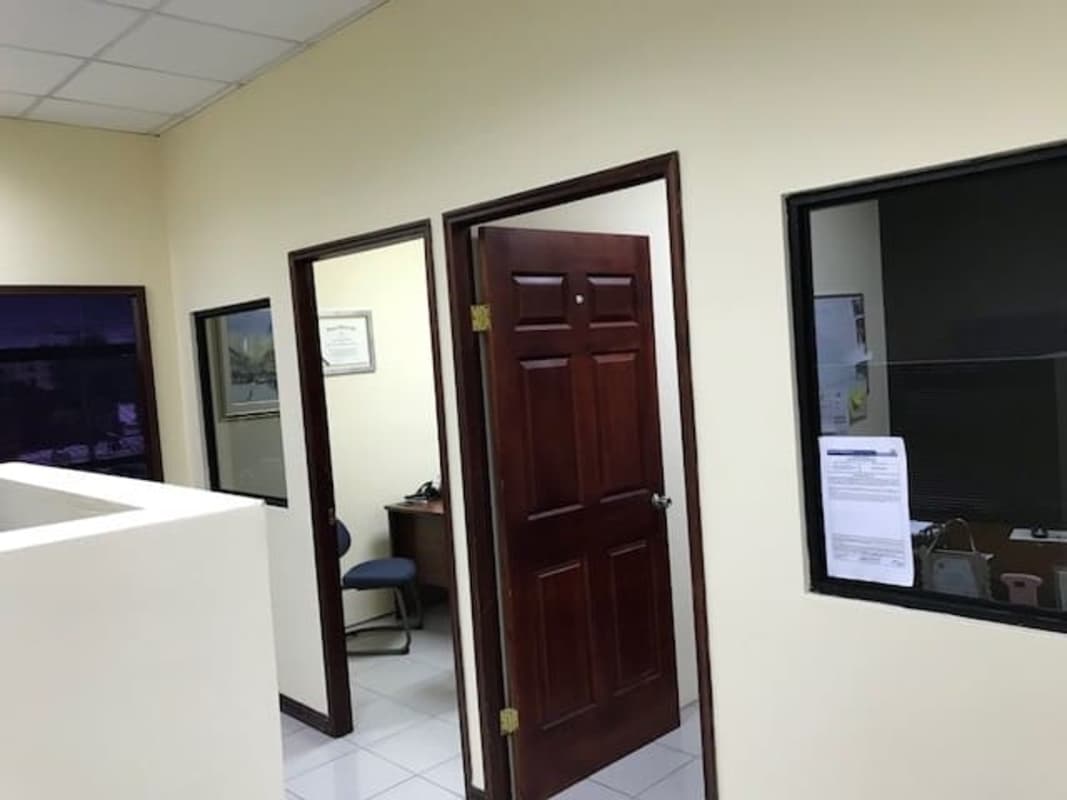 Modern office space with cubicles, shelves, air conditioner and interior window PH Mall 50 Panama
