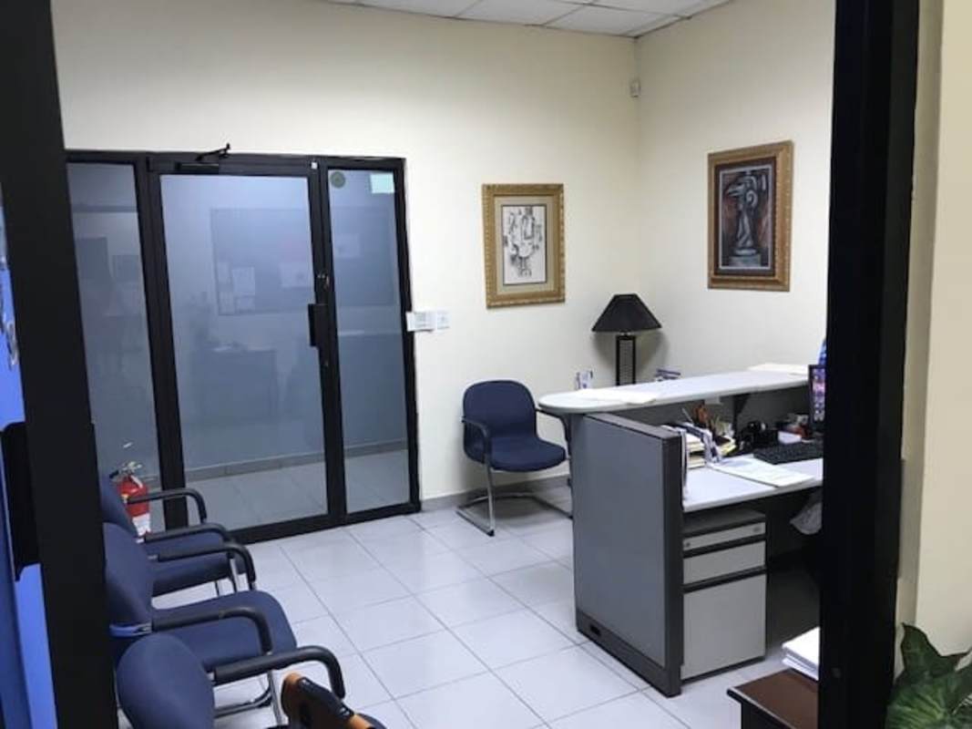 Office hallway with wooden doors, glass panels, tiled floor, modern lighting PH Mall 50 Panama